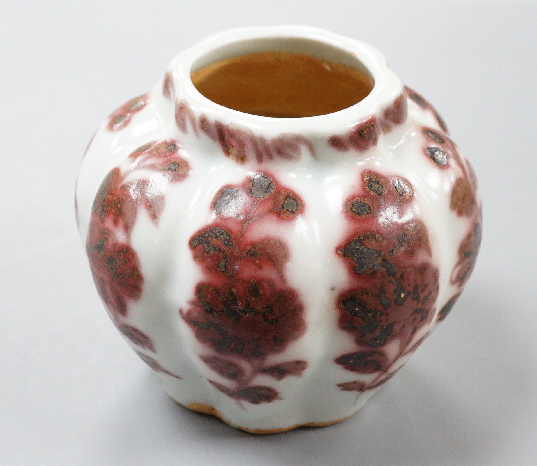 A Chinese underglaze copper red lobed jar, 9cm tall